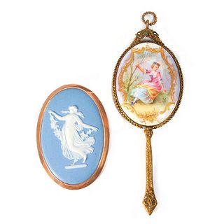 A Wedgewood brooch and a mirror.