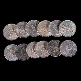 Twelve Chinese emperor coins.