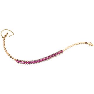 BRACELET WITH RUBIES AND DIAMONDS IN 12K GOLD AND WHITE GOLD with 30 rubies and 58 diamonds. Weight: 10.8 g