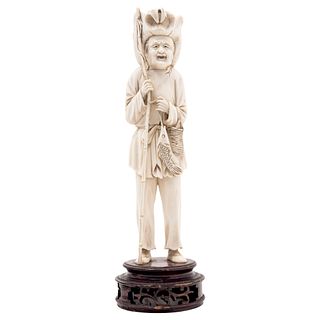 ANCIENT FISHERMAN. CHINA, 20th Century. Ivory carving. Includes wooden base. 9" (23 cm) tall.