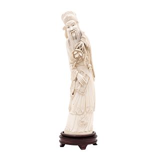 WISE MAN WITH FLOWERS. CHINA, 20th Century. Ivory carving with ink details.Signed on the bottom with an image. 15.3" (39 cm) tall.