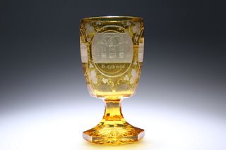 A GERMAN AMBER GLASS GOBLET, 19th CENTURY, the bowl etched with named archi