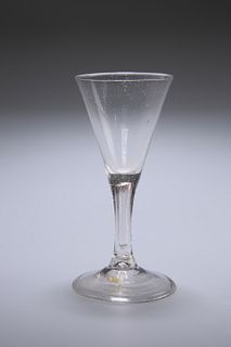 A WINE GLASS, CIRCA 1740, with drawn conical bowl on hollow stem with elong