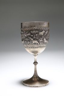 AN INDIAN WHITE METAL GOBLET, the cup embossed with elephants, lions and ot