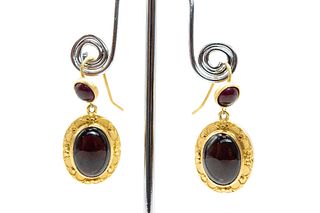 A PAIR OF GARNET EARRINGS
 The oval cabochon garnet within a polished frame
