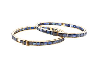 A PAIR OF SAPPHIRE BANGLES
 Each hinged bangle collet-set with rectangular-