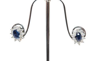 A PAIR OF SAPPHIRE AND DIAMOND CLUSTER EARRINGS 
 The claw-set oval-shaped 