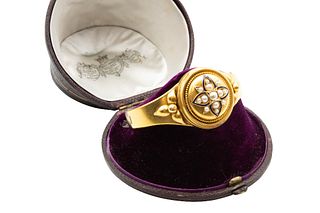 A HALF PEARL AND ENAMEL BANGLE, CIRCA 1871
 The hinged bangle centred by a 