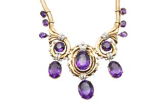 AN AMETHYST AND DIAMOND NECKLACE
 The central pendant set with an oval-shap