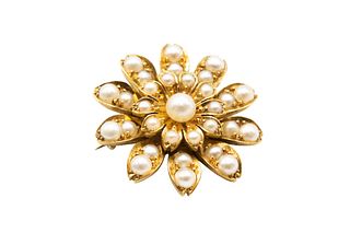 A PEARL FLOWER BROOCH 
 The realistically modeled flowerhead, with a centra