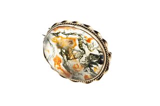 A DENDRITIC AGATE BROOCH
 The oval cabochon dendritic agate, contained with