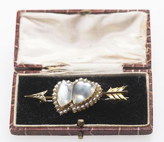 A MOONSTONE AND SEED PEARL BROOCH, CIRCA 1895
 Designed as a double-heart a