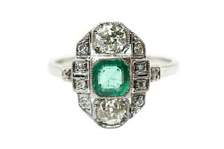 AN EMERALD AND DIAMOND DRESS RING
 The elongated plaque centred by an octag