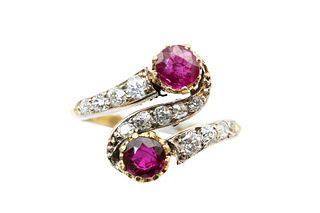 A RUBY AND DIAMOND CROSSOVER RING
 Of swirling design, set with a duo of ci