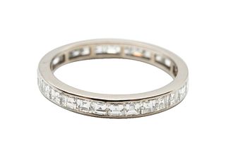 A DIAMOND ETERNITY RING
 Channel-set with a row of square step-cut diamonds