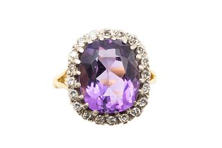 AN AMETHYST AND DIAMOND CLUSTER RING
 The cushion-cut amethyst, within a su