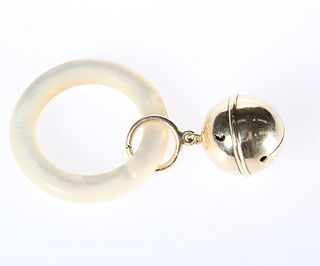 A GOLD BABY'S RATTLE, the bell loop stamped 14K, on a mother-of-pearl teeth