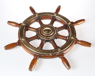 A BRASS-MOUNTED TEAK SHIPS WHEEL, of eight-spoke design. 60.5cm