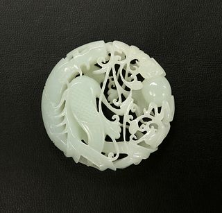 A CHINESE JADE AMULET, filigree carved with phoenix amidst scrolling foliag