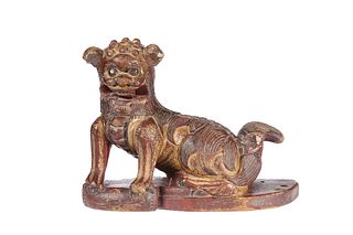 A CHINESE CARVED WOODEN MODEL OF A FOO DOG, gilded and painted, probably 19