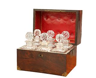 A GEORGE III MAHOGANY DECANTER BOX, the flame mahogany case with brass-boun