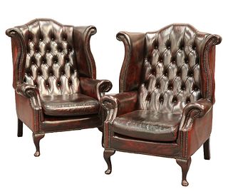 A PAIR OF BUTTON-BACK OX-BLOOD LEATHER WING CHAIRS, each with out-scrolled 