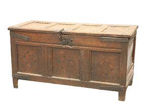 A LATE 17TH CENTURY OAK COFFER, the four-panel lid over a three panel front