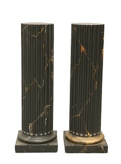 A PAIR OF FAUX MARBLE COMPOSITION COLUMNS, each fluted column raised on a s