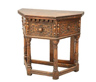 AN OAK CREDENCE TABLE, the foldover top above a drawer with carved front, f