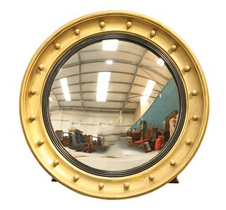 A LARGE REGENCY GILT-COMPOSITION CONVEX MIRROR, with applied balls. 63cm di