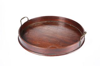 A GEORGE III MAHOGANY GALLERIED CIRCULAR TRAY, with brass handles. 47cm dia