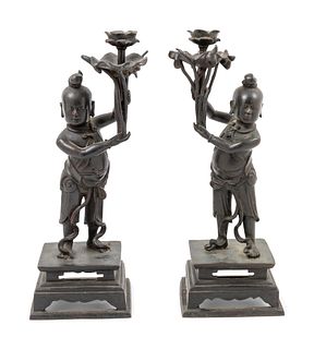 A Pair of Bronze 'Boy' Candle HoldersHeight 17 in., 43 cm.