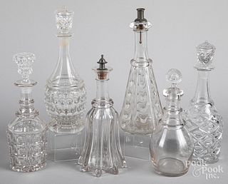 Six colorless glass decanters. 19th c.