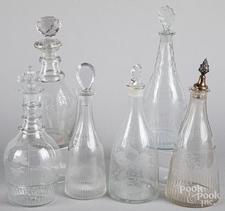 Six engraved colorless glass decanters, 19th c.