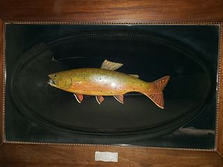 Carving of a brook trout under Victorian period domed glass.