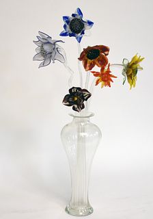 Signed glass vase containing art glass flowers