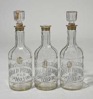 Three enameled Jack Daniels decanters