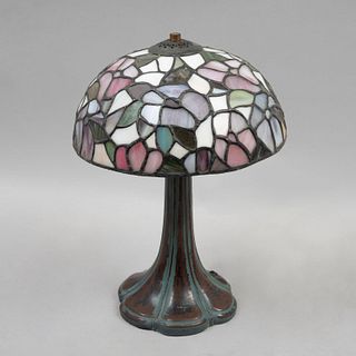 Lámpara de mesa. Siglo XX. Elaborada en antimonio con pantalla de vidrio emplomado tipo Tiffany. Para 2 luces.