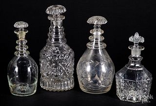 Four colorless glass decanters