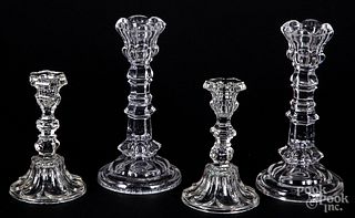 Two pairs of colorless glass candlesticks
