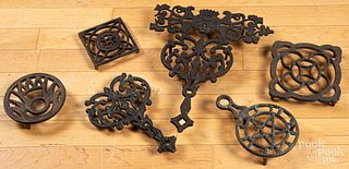 Six cast iron trivets