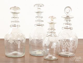 Four etched colorless glass decanters