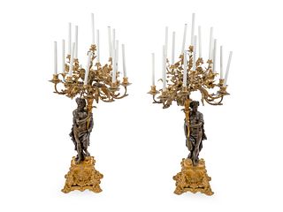 A Pair of Large French Gilt and Patinated Bronze Fourteen-Light Candelabra Height overall 45 inches.