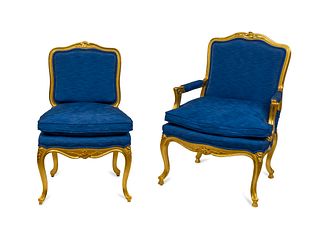 A Set of Fourteen Italian Louis XV Style Giltwood Dining Chairs Height 40 inches.