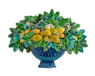 A Glazed Ceramic Wall Plaque of a Basket of Fruit and Flowers