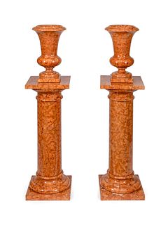 A Pair of Red Marble Urns on Pedestals Height 53 1/2 inches.