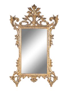 An Italian Rococo Giltwood Mirror Height 46 x width 26 inches.