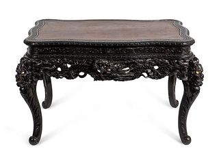 A Japanese Export Carved and Ebonized Wood Center Table Height 30 1/2 x width 51 x depth 35 inches.