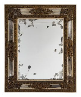 A Venetian Style Repousse Brass Mounted Cushion Frame Mirror
Height 49 x width 40 1/4 inches.