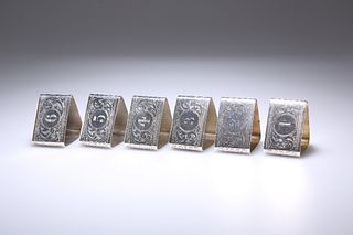 A SET OF SIX GEORGE V SILVER NAPKIN RINGS
 by Dock